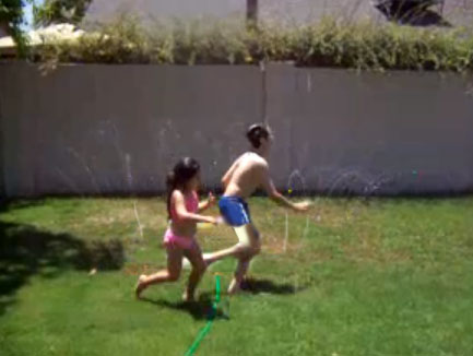 kids playing in sprinkler